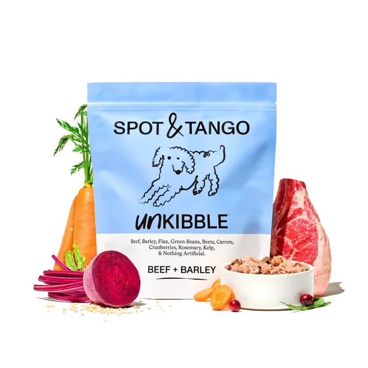 A bag of Beef and Barley UnKibble surrounded by fresh beef, beets and carrots